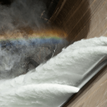 Hydrodam with rainbow over water